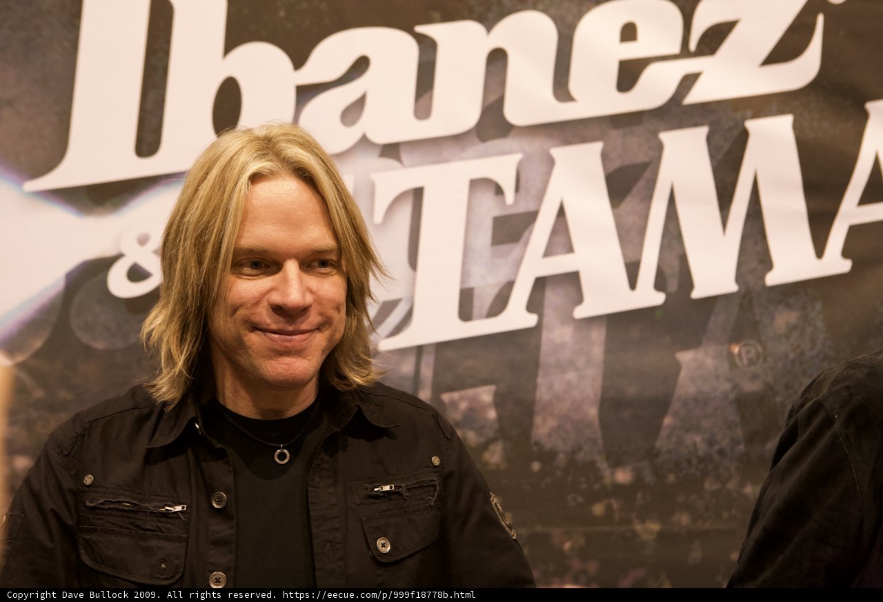 Andy Timmons poses in front of iconic danez tama sign at NAMM 2009