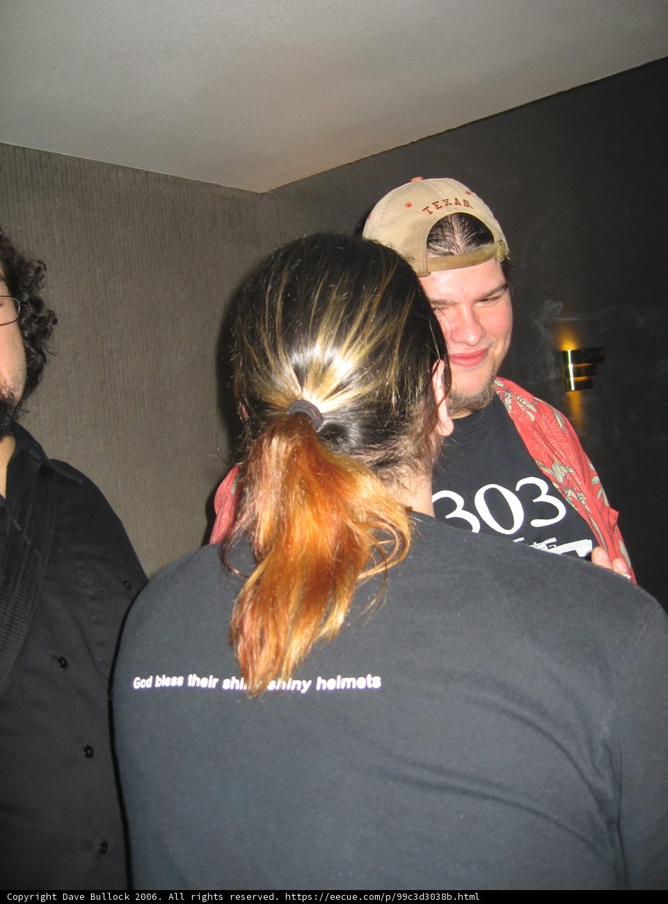 Black-Shirted Man with Ponytail and Baseball Cap
