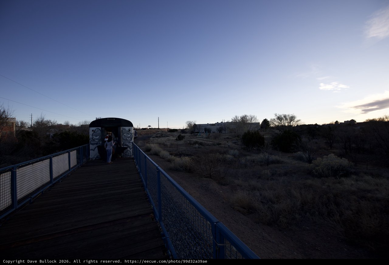 Twilight Crossing: Blue Bridge and Desert Landscape at Dusk