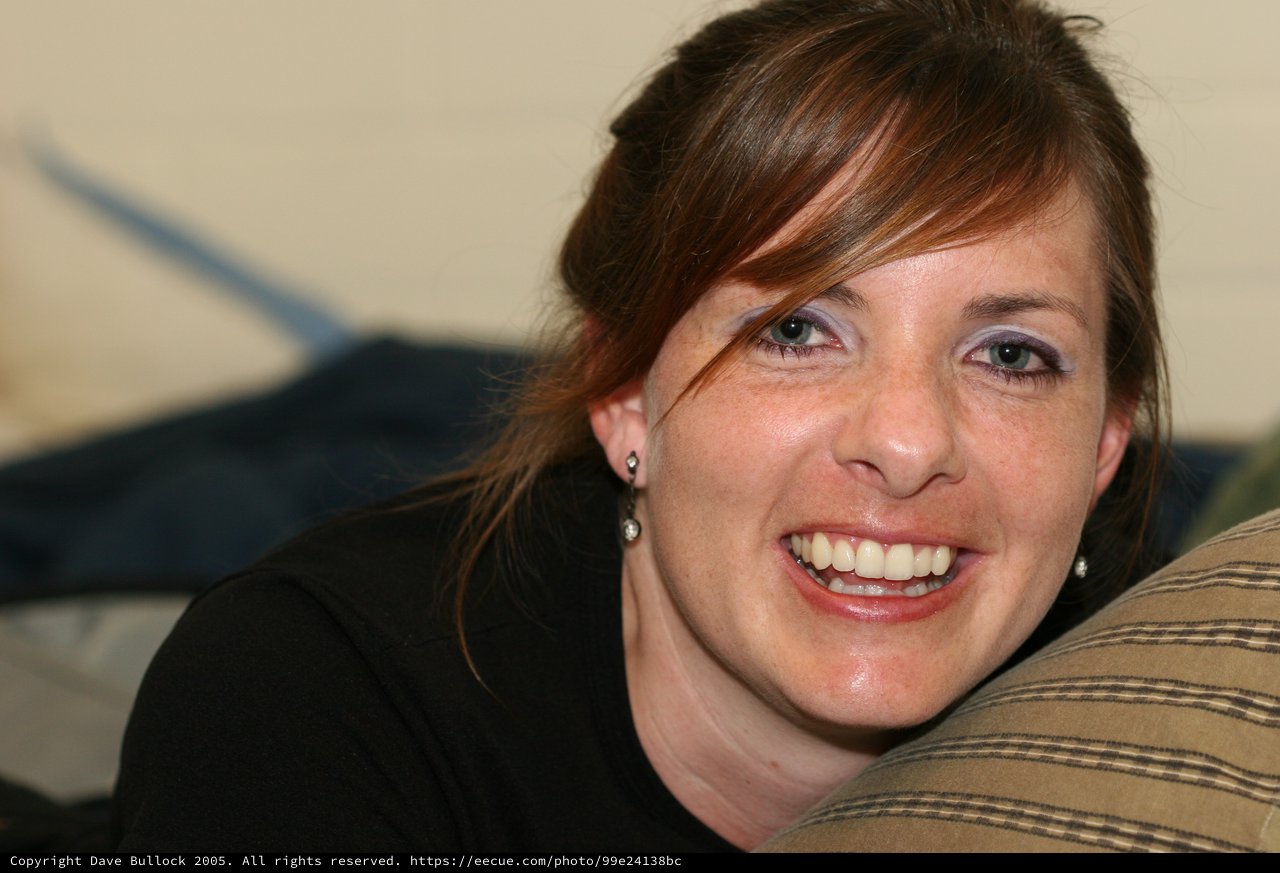 Radiant Woman Smiling Candidly on Living Room Sofa