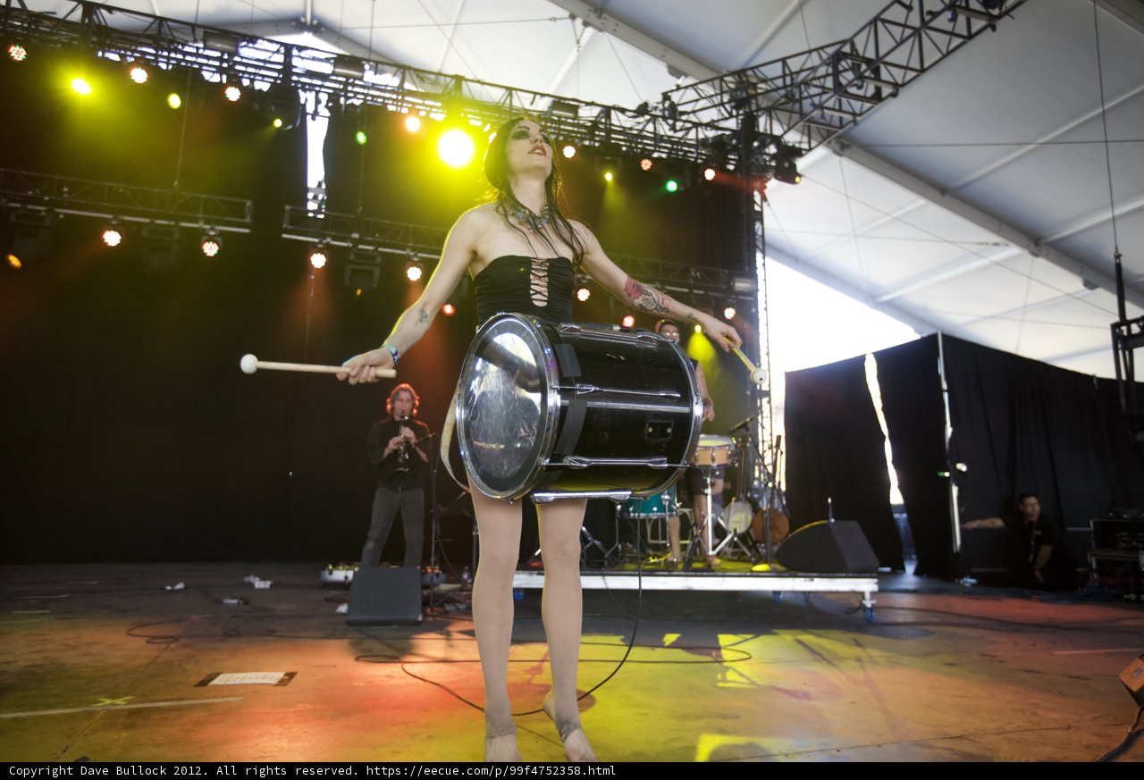 Tattooed Woman Drumming Under the Spotlight
