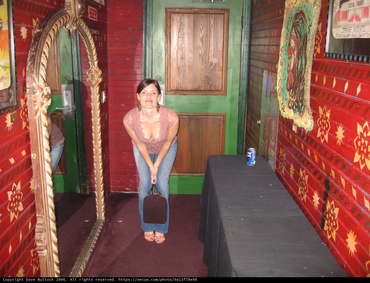 Woman Posing in Eclectic Red-Walled Venue Hallway