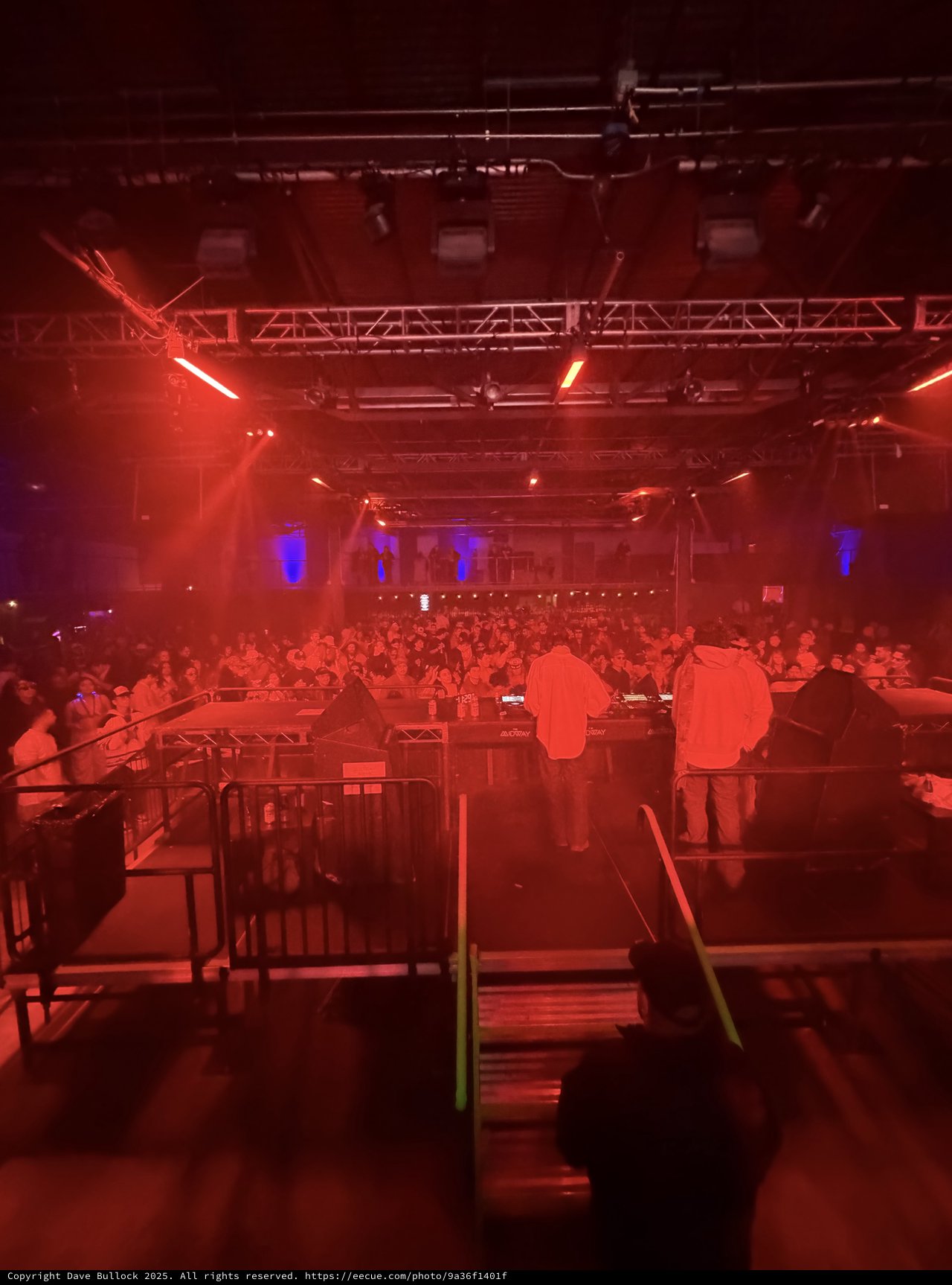 Electronic Music Event with Red Stage Lighting and Crowd