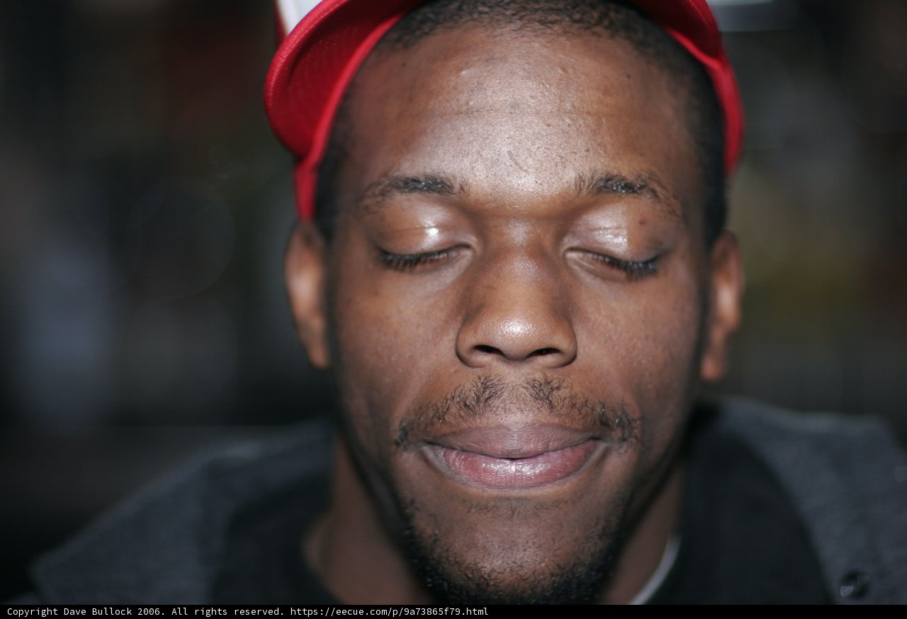 Man in Red Hat with Closed Eyes