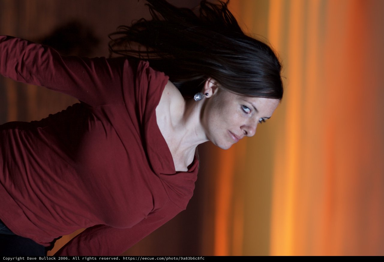 Woman Gazing Upward Against Fiery Sunset Sky