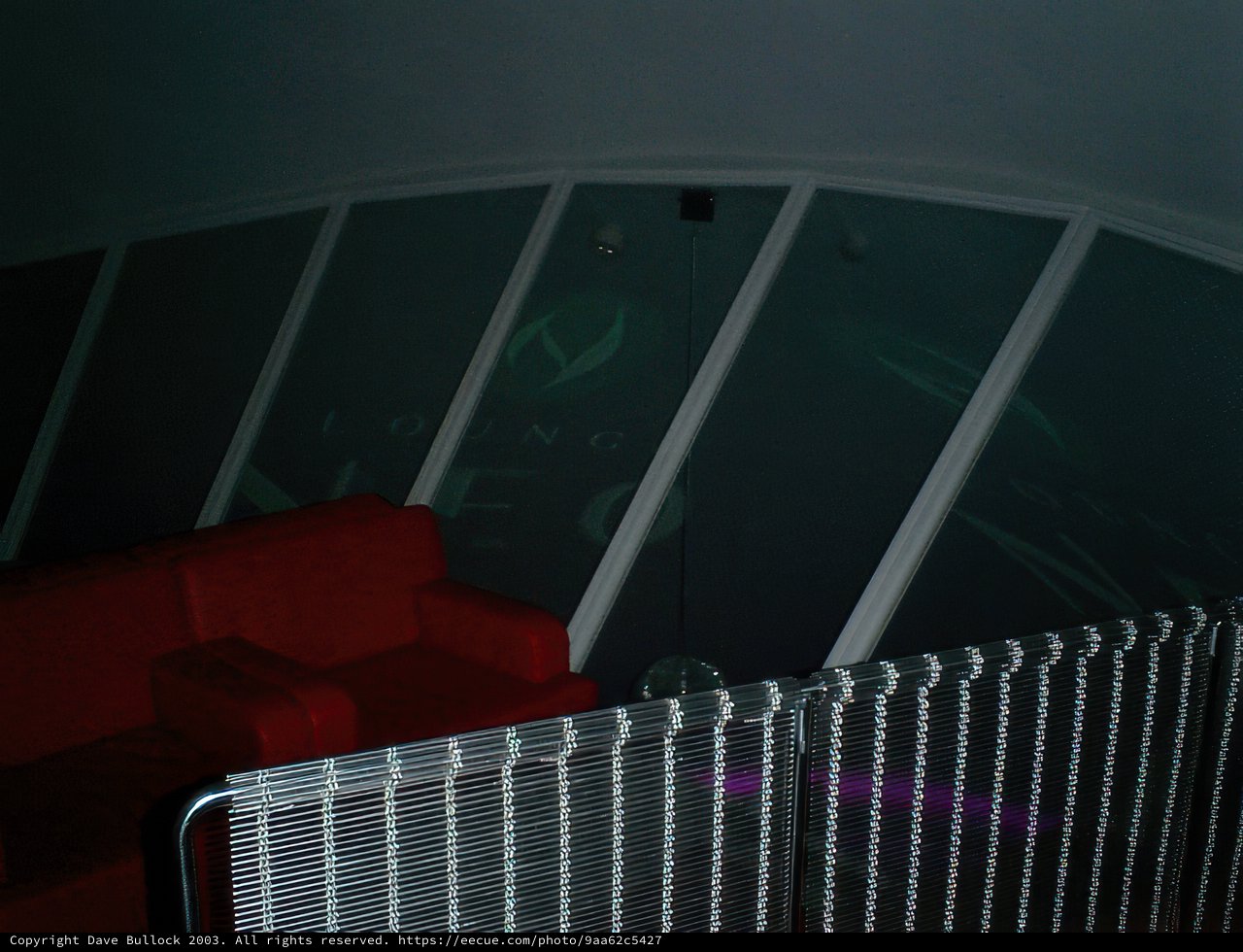 Red Couch Against Glass Wall