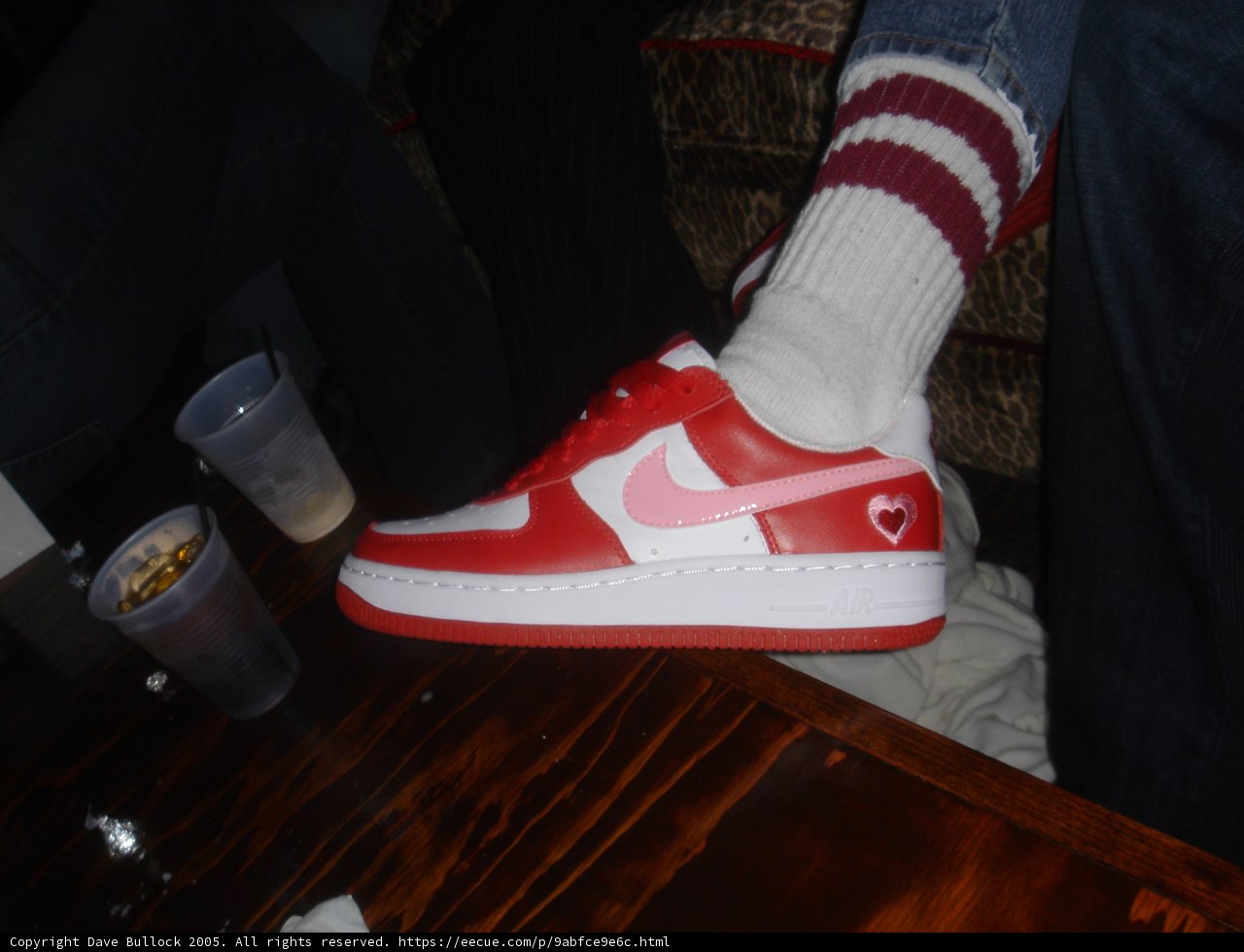 Red and White Nike Shoe on Hardwood