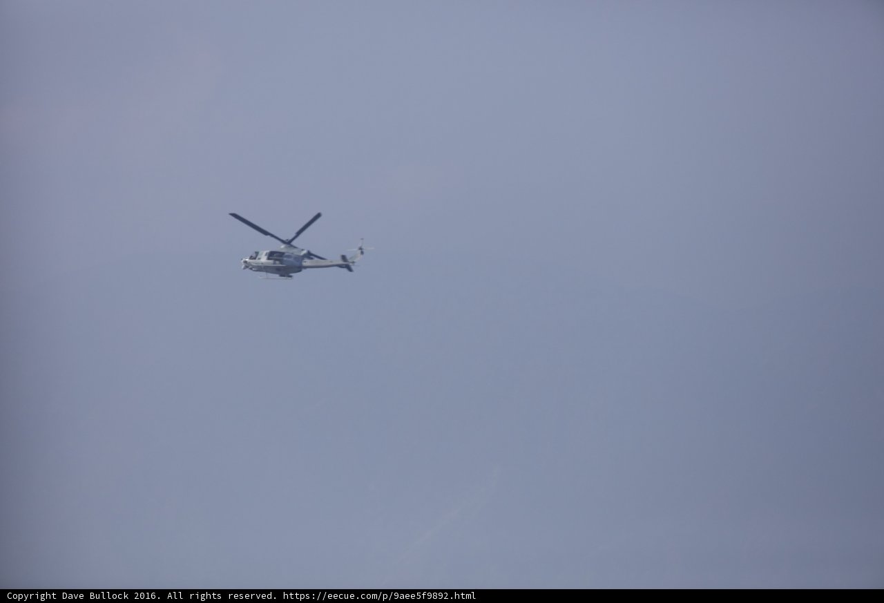 Helicopter Soaring over Majestic Mountain Range