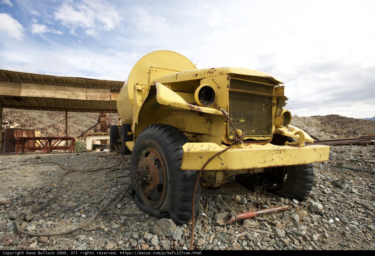 Yellow Truck on Gravel Road