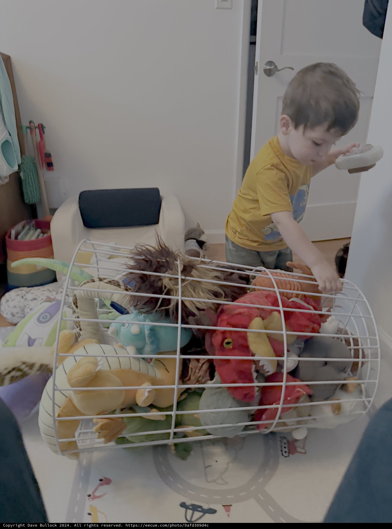 Child Playing with Toys in Wire Basket