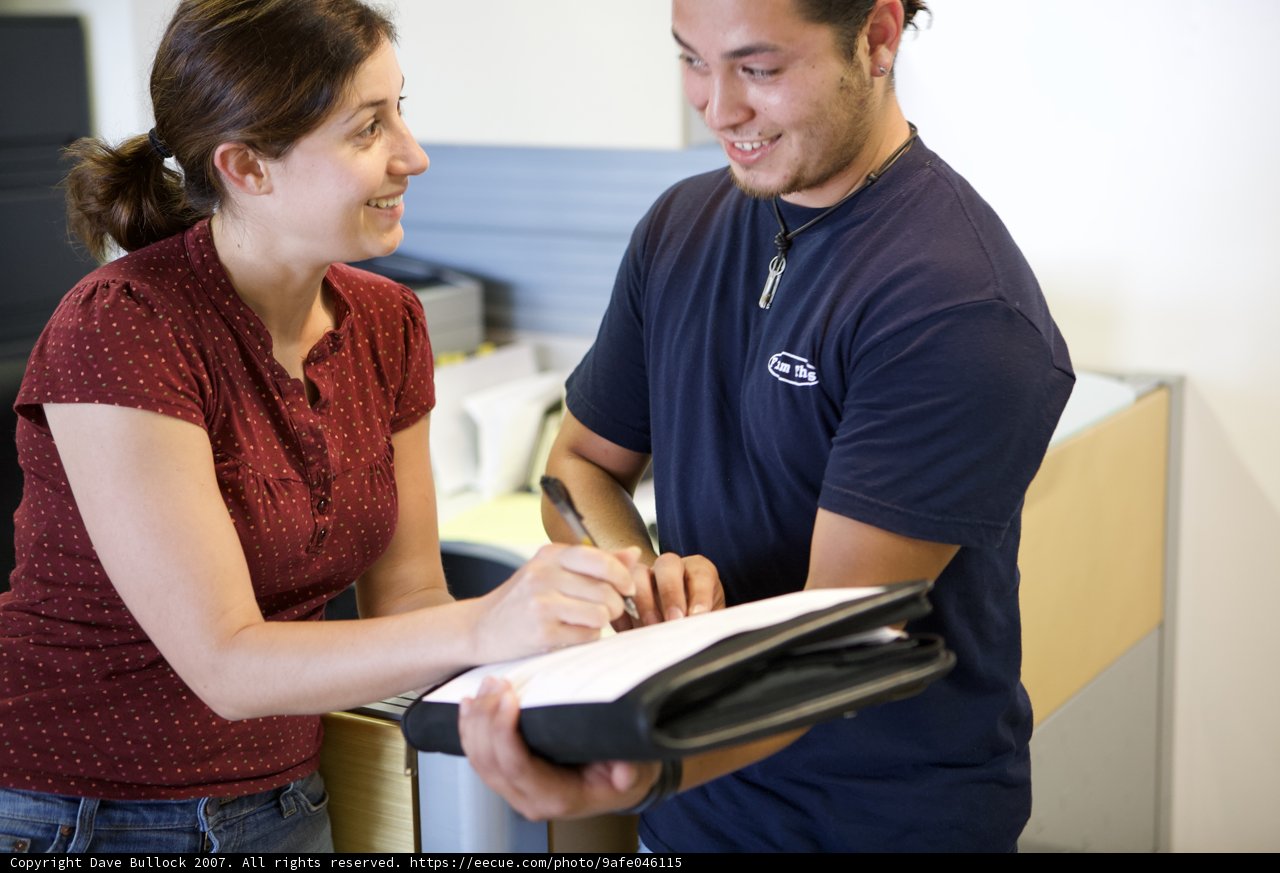 Smiling Couple with Pen and Book