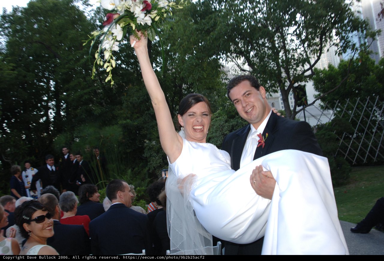 Joyful Bride Lifted by Groom After Wedding Ceremony