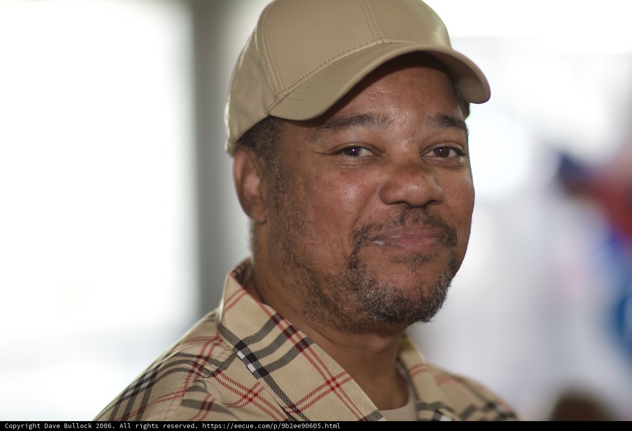 Man in Plaid Shirt and Baseball Cap