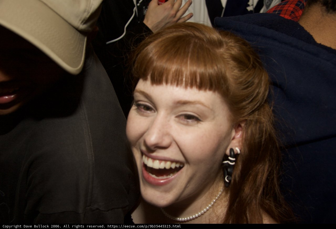 Red-Haired Woman Wearing a Baseball Cap and Hoodie