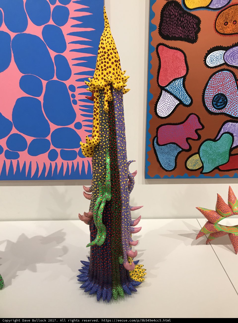 Artistic Fusion: A Vibrant Sculpture Complements a Striking Painting