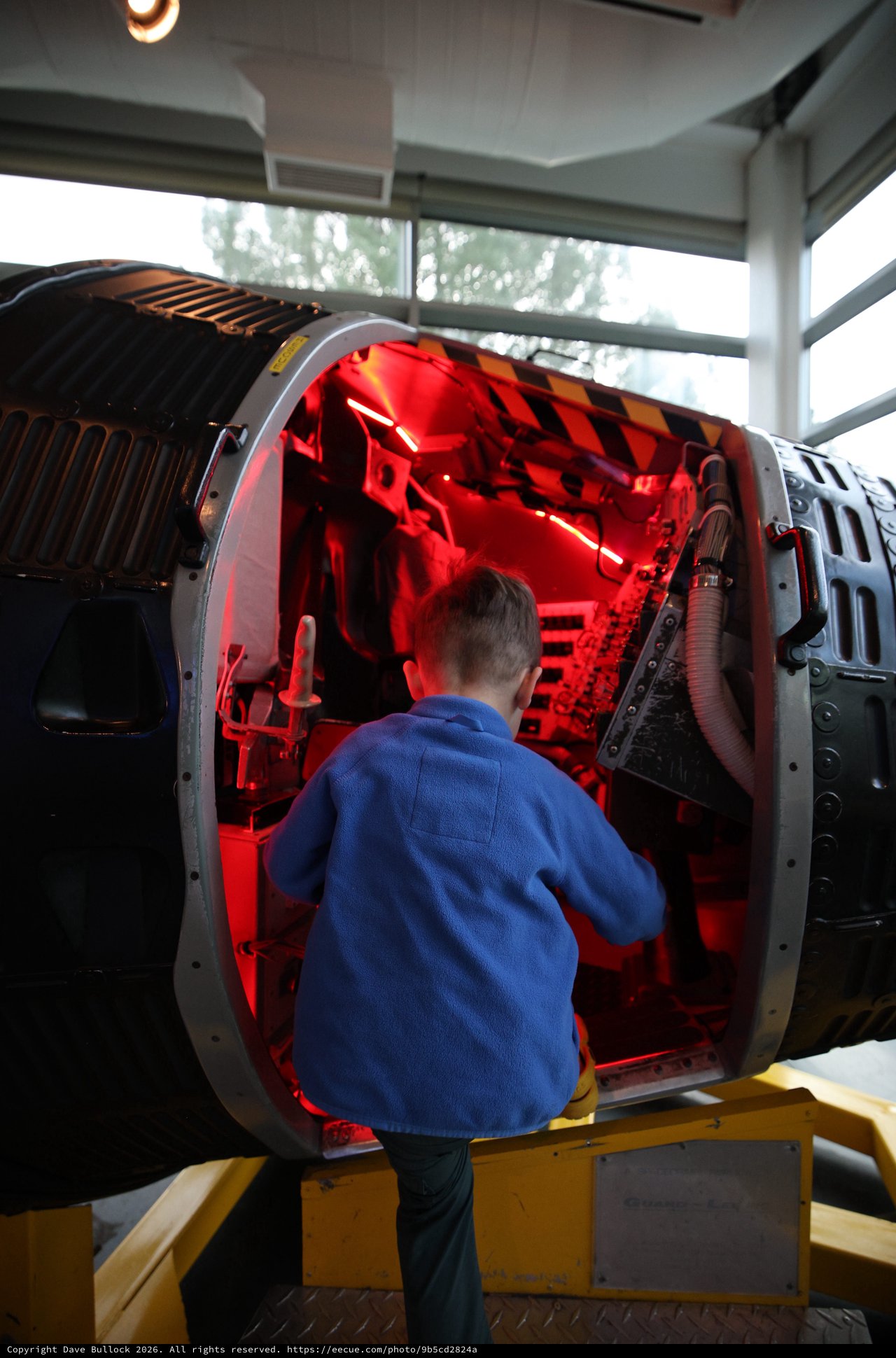Child Exploring Illuminated Aerospace Engine Display