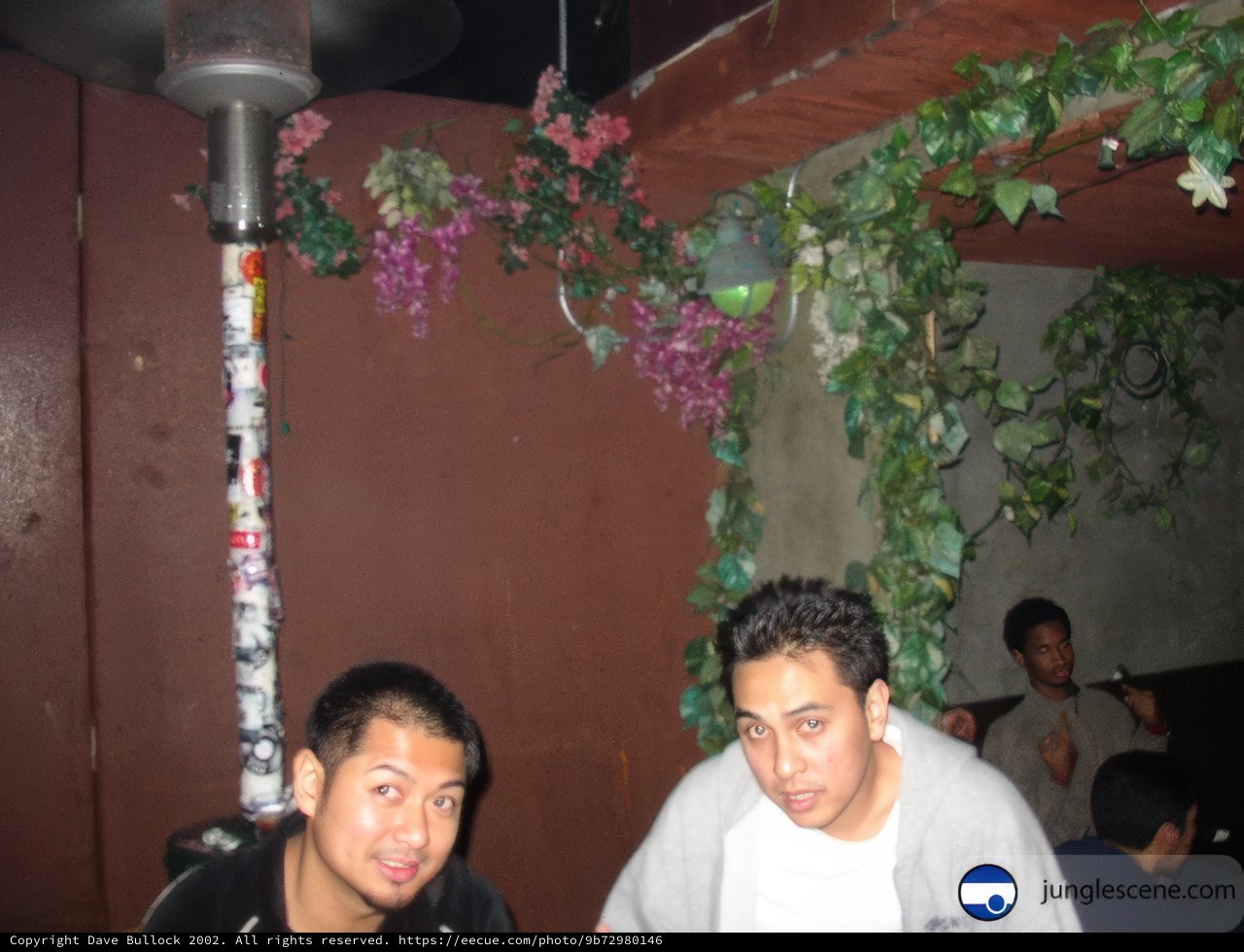 Two Men Enjoying a Drink at an Outdoor Pub