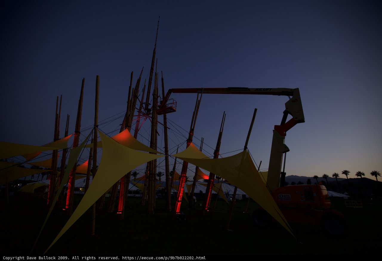 Crane lifts massive tent into the night sky