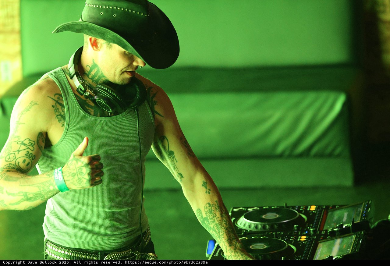 Tattooed DJ in Cowboy Hat Commands the Decks