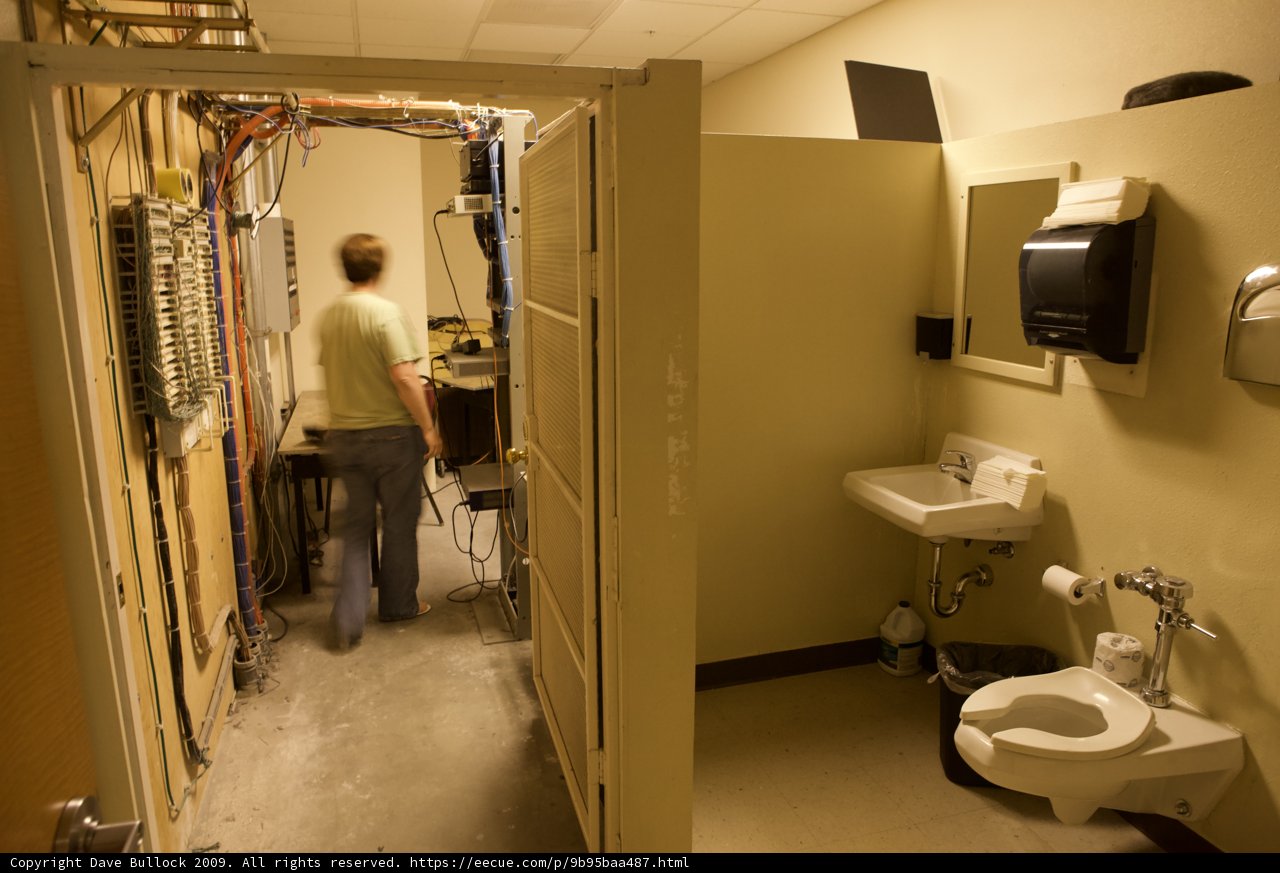 A Man Walks Through a Clinic Bathroom