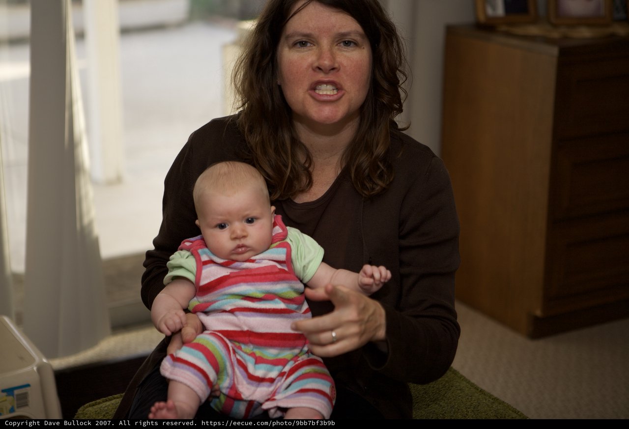 Frustrated Mother Holds Baby in Living Room