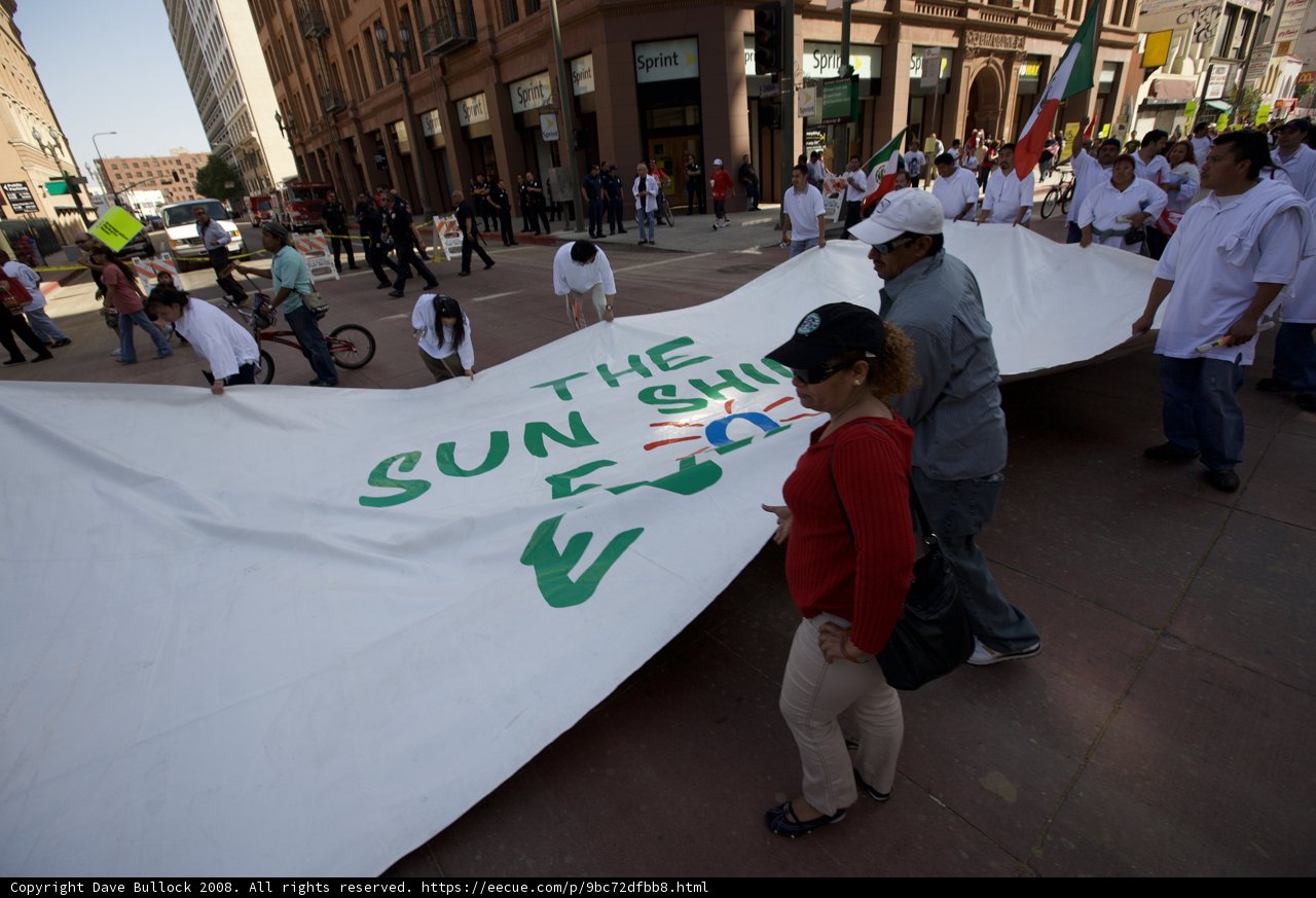 Mayday Rally Banner Holding Crowd
