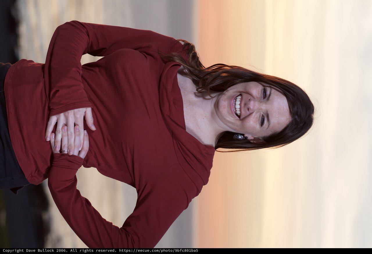 Joyful Woman Laughing at Coastal Sunset