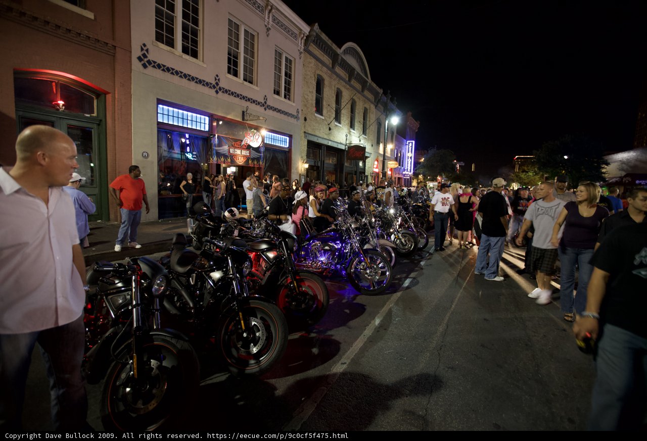 Motorcycle enthusiasts gather under the night sky
