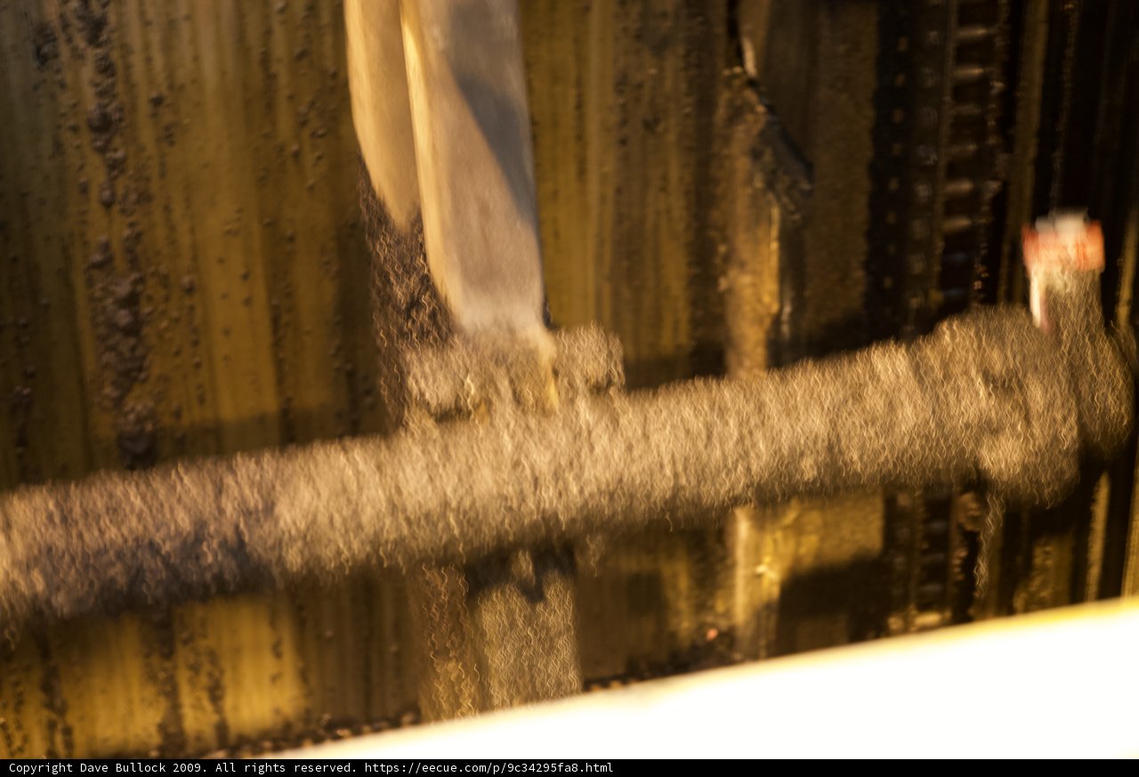Wooden Handrail Supported by Rusty Pipe