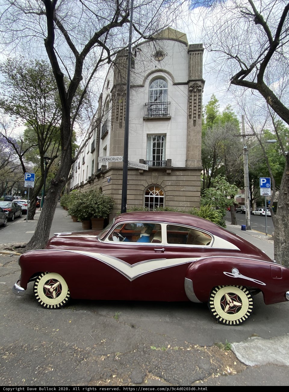 Maroon Coupe Parked in Urban Mexico