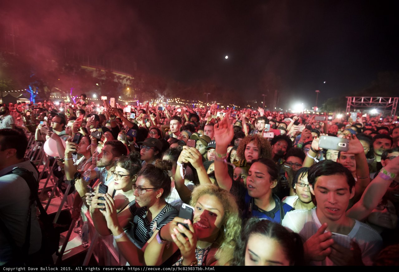 FYF Fest Wide Crowd Many Faces Moon Night Phones Woman Striped Shirt Curly Hair Diverse Stage Scaffolding