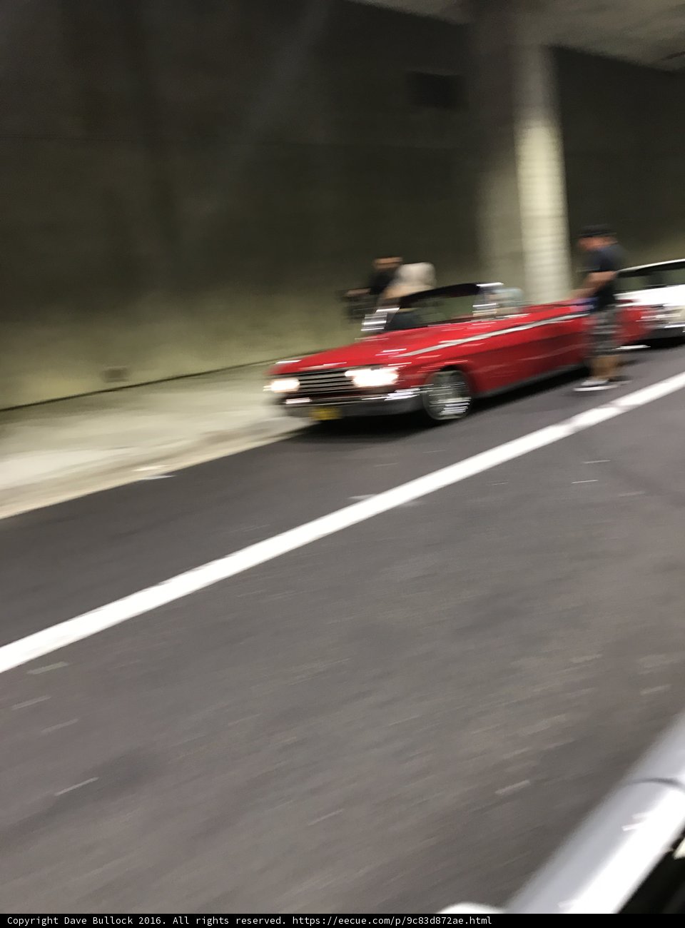 Red Sports Car Cruising Through the Tunnel
