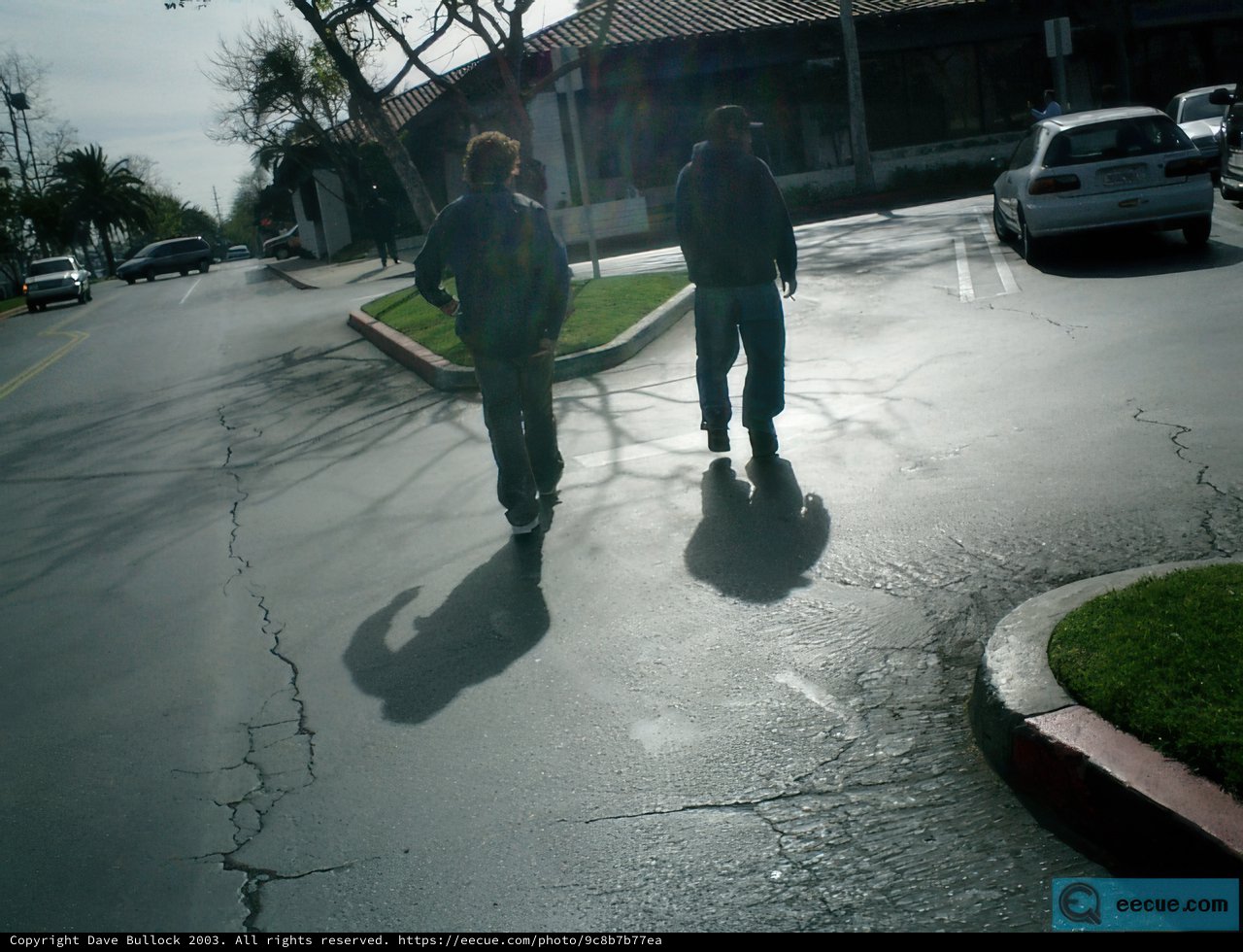 Two Men Walking Down an Urban Street