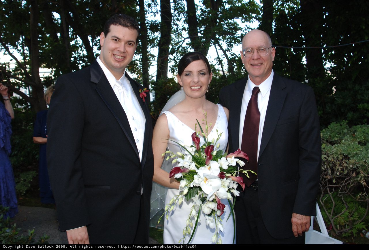 Joyful Wedding Trio Portrait in Garden Setting