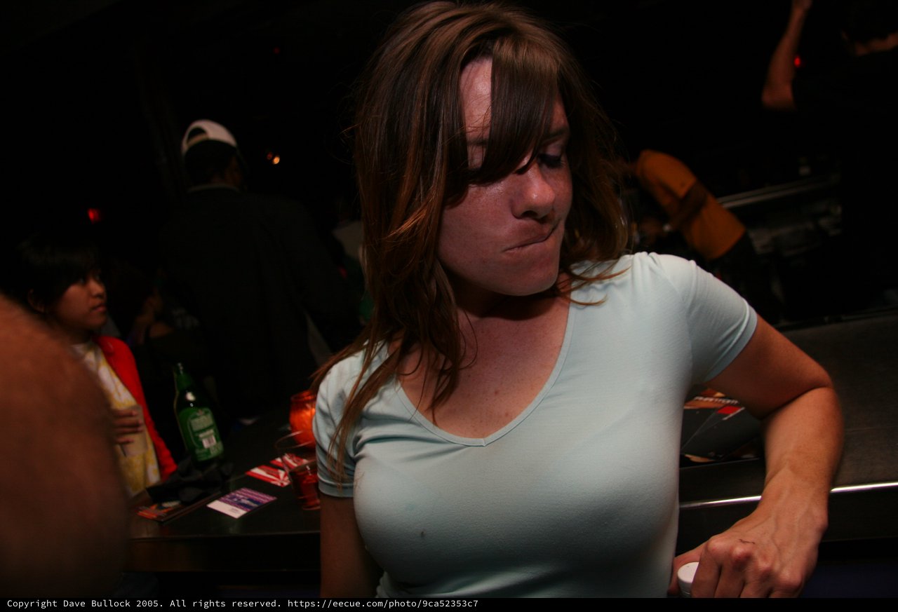 Young Woman at Crowded Nightclub Bar Scene