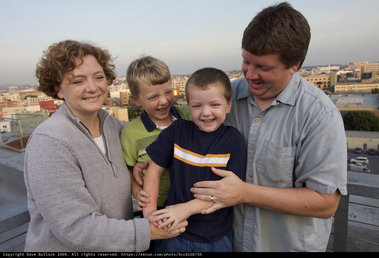 Happy Family Portrait on Urban Rooftop at Dusk