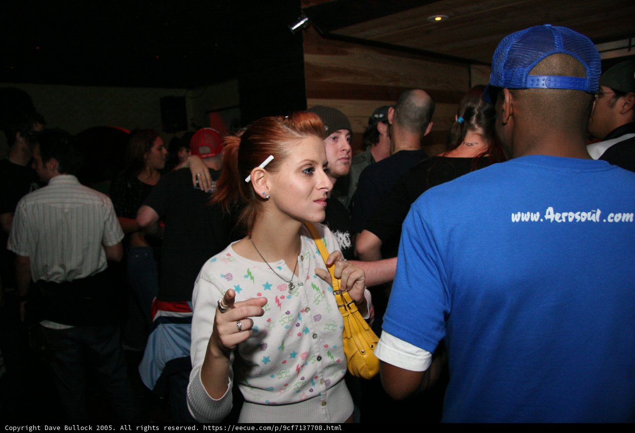 Blue-Shirted Woman in a Baseball Cap