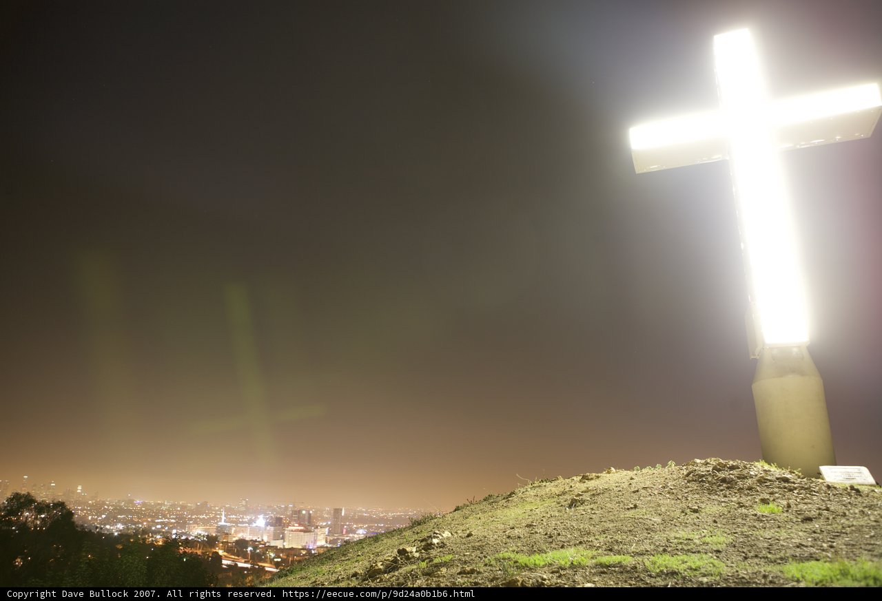 Cross on Hill with Cityscape