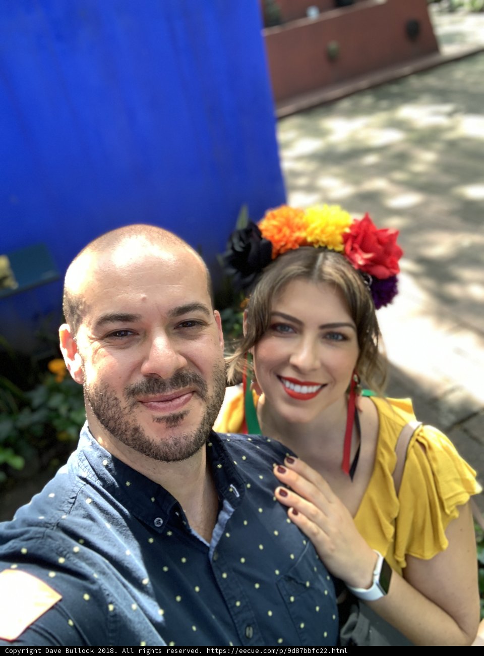 Happy selfie in front of blue wall