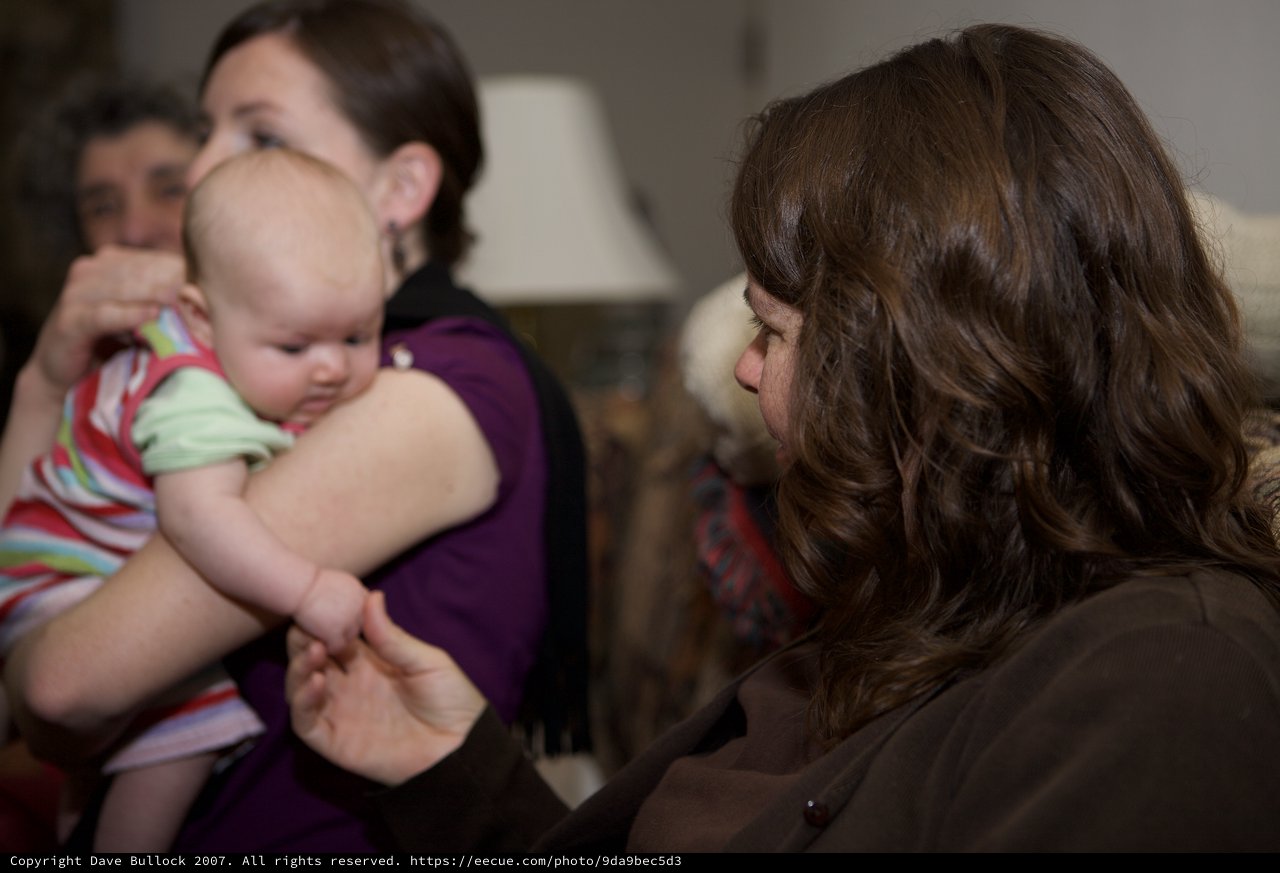 Tender Moment: Woman Reaches for Baby's Hand