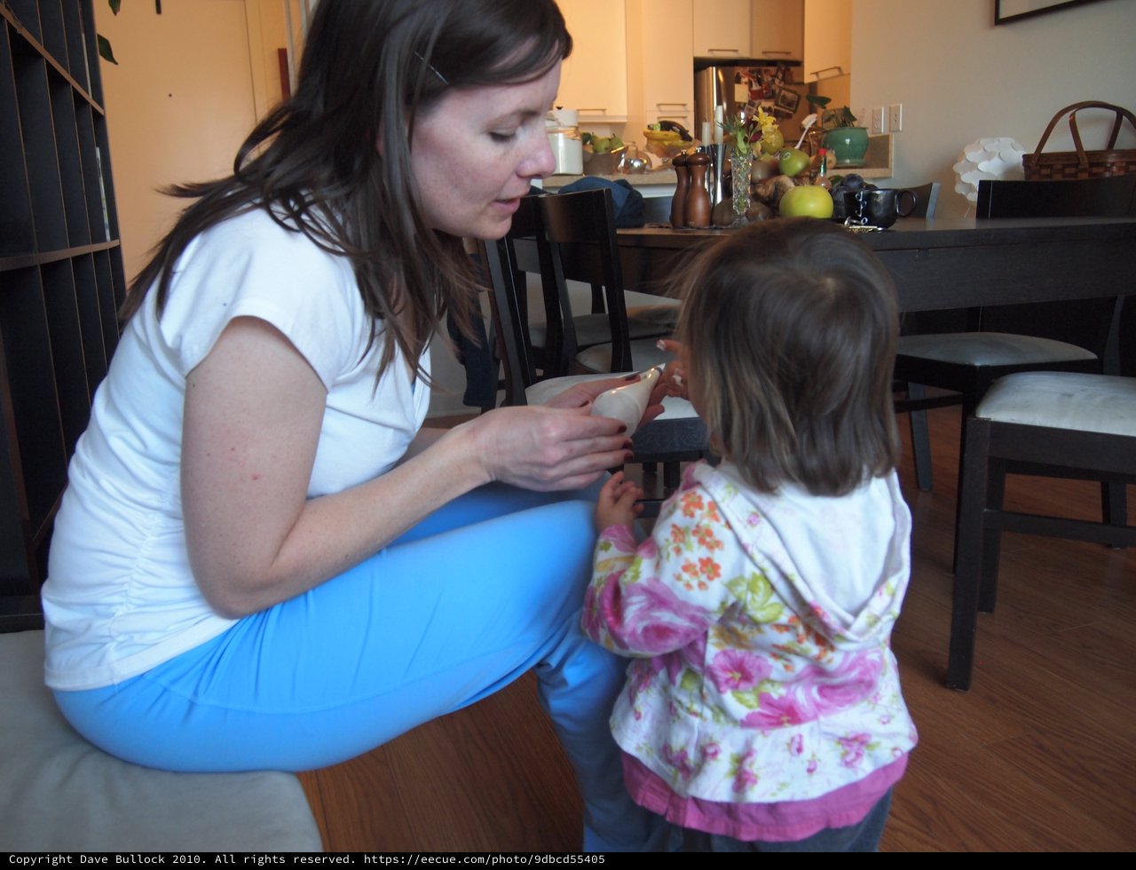 Mother and Toddler Sharing a Snack at Home