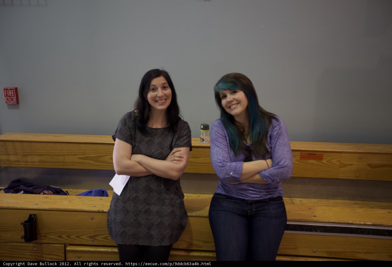 Two Women Relaxing on Wooden Bench in Room