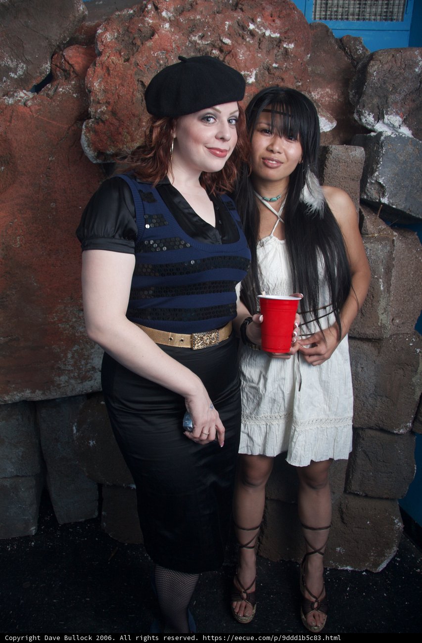 Two Women Sipping From Cups