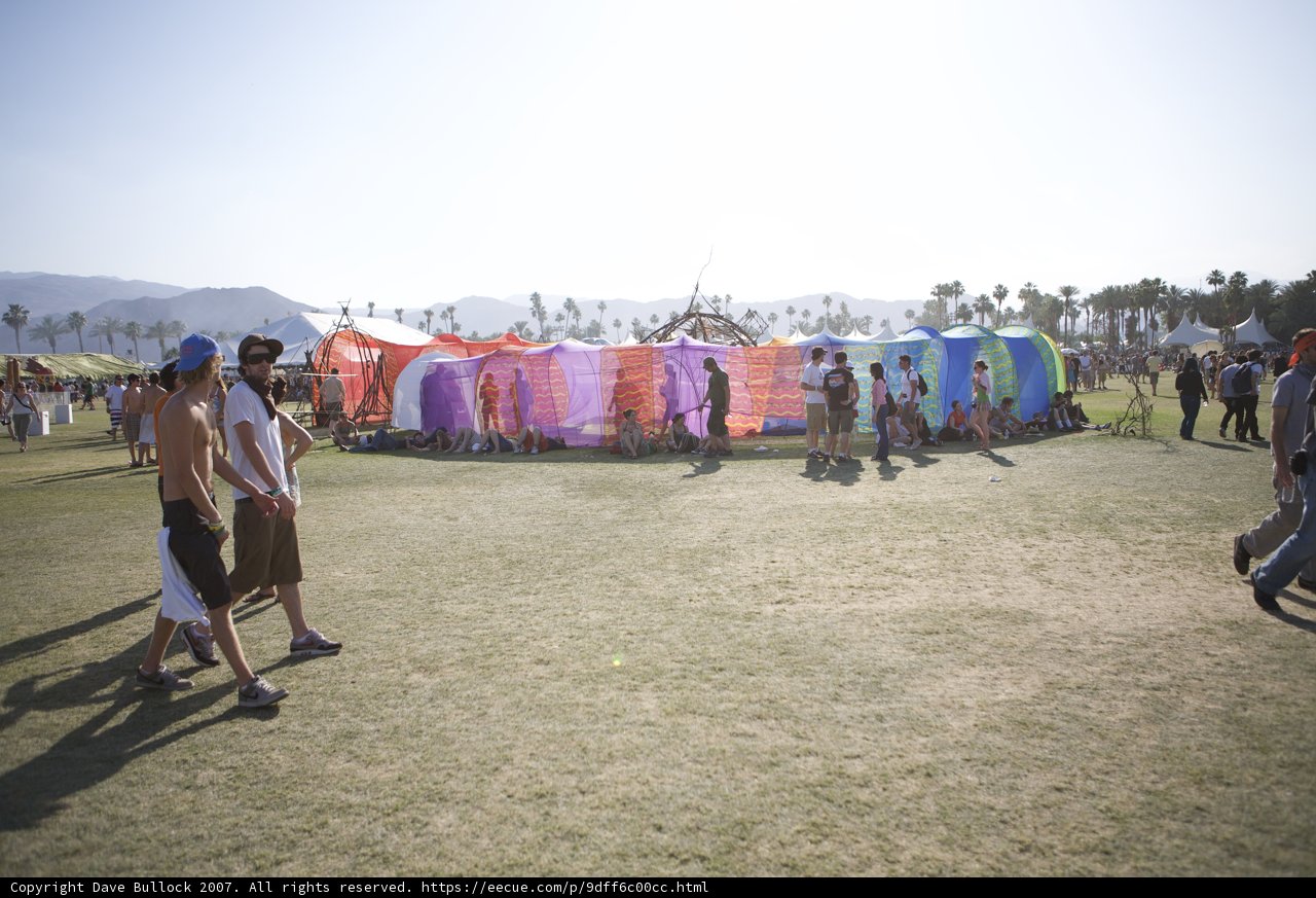 Festival Goers Take Shelter Under Colorful Tent