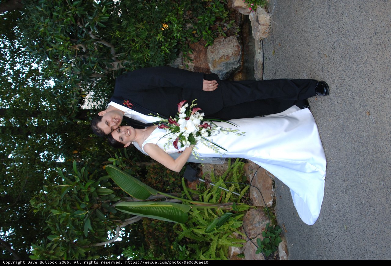 Bride and Groom Embrace in Lush Garden Setting