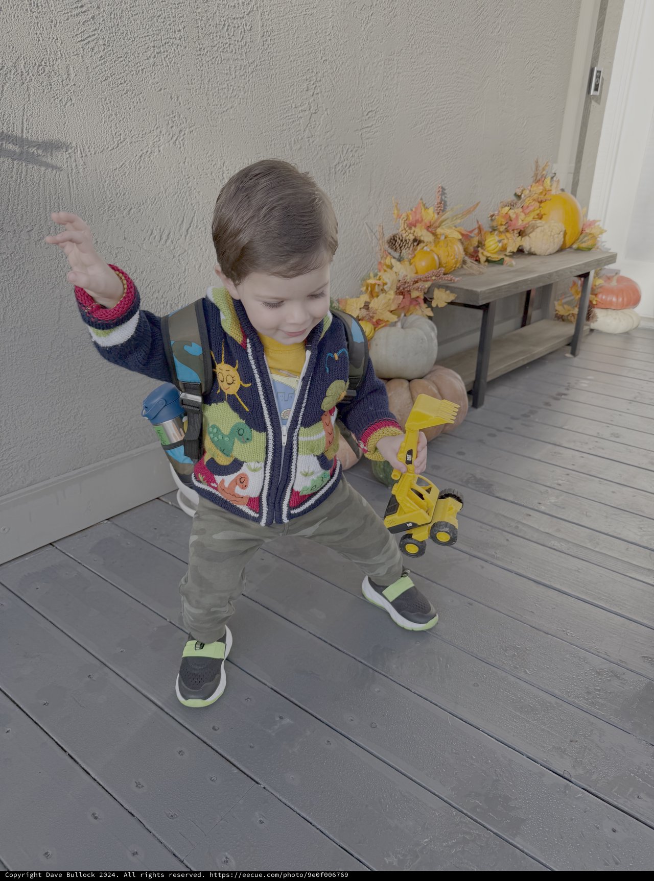 Toddler Playing with Yellow Toy Truck Indoors