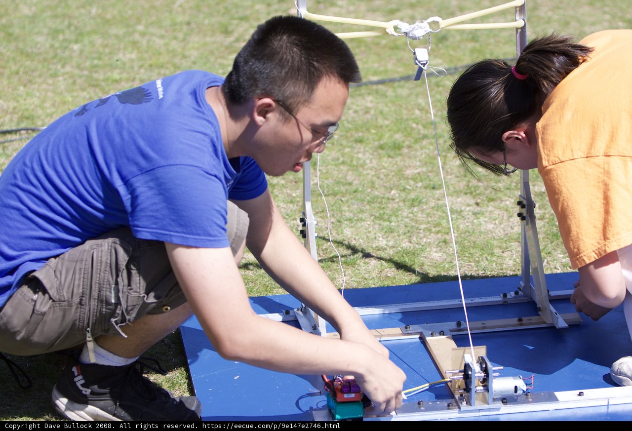 Engineering Duo Works on a Small Device Outdoors