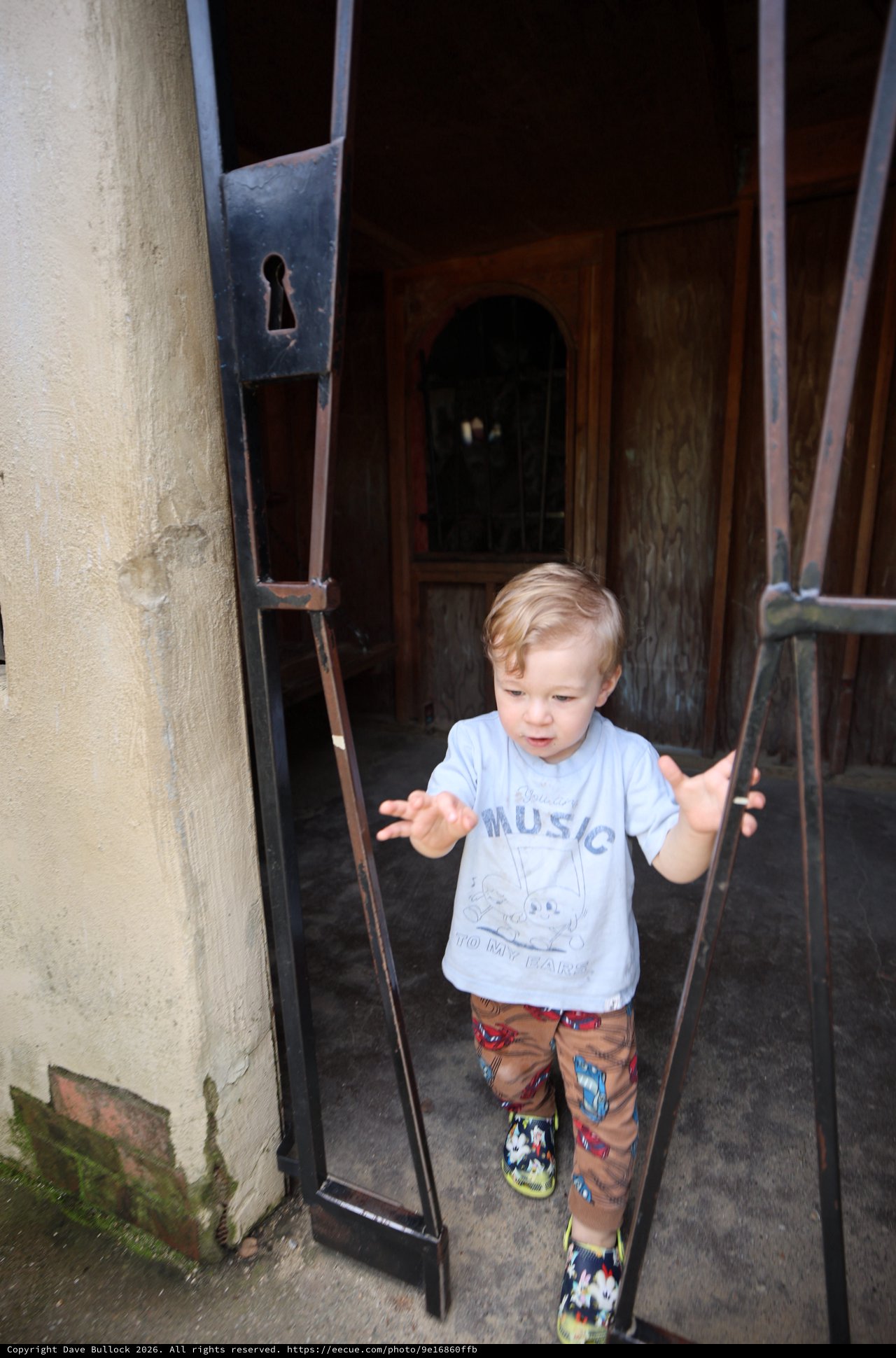 Young Boy Stepping Through Historic European Doorway