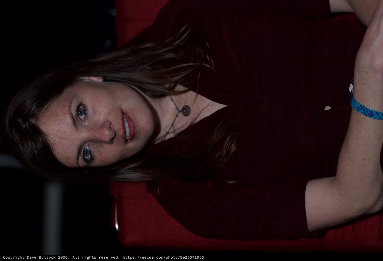 Woman in Red Chair with Pensive Gaze