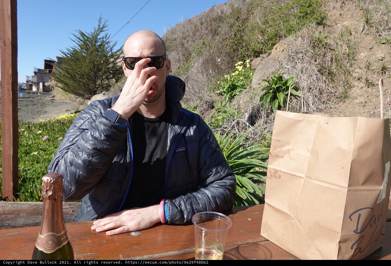 Man Enjoying Outdoor Meal with Champagne